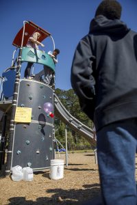 University of Alabama education majors and elementary students simulate a lunar landing on a playground.