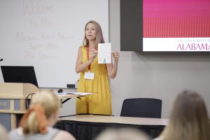 An education researcher speaks to teachers at a conference.