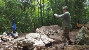 A professor at The University of Alabama works on an archaeological project in Mayan ruins.