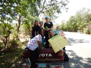 Students riding in the back of a pickup truck in the Dominican Republic
