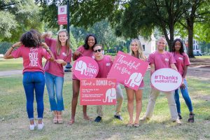 UA students pose with signs thanking donors