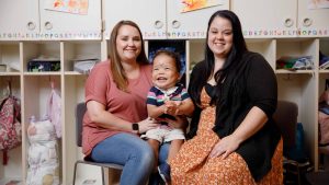 Nurse, RISE student and student's mother sit together 