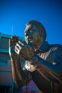 A statue of Nick Saban appears to clap its hands. 