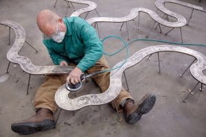 Wedderspoon sculpts the shape of the Black Warrior River for the bicentennial timeline. 