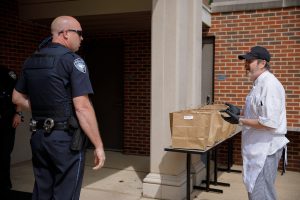 A restaurant worker delivers food to UAPD.
