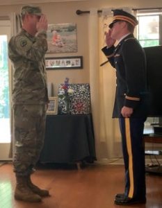 Soldier in fatigues saluting officer in uniform 