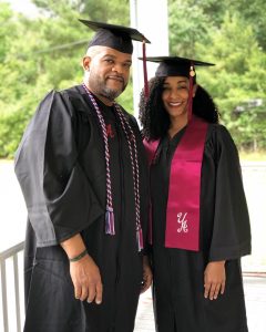 Husband and wife in their cap and gown.