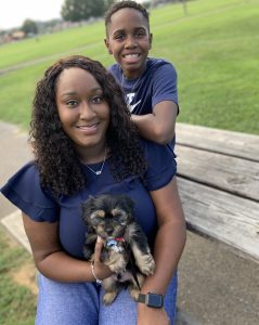 Epiphany Wells poses with her son and puppy.