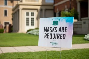 Yard sign that reads, "Masks are required."