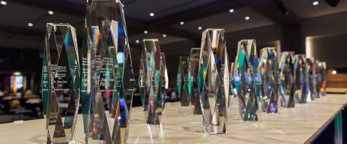 crystal awards displayed on long table for honoring faculty and staff