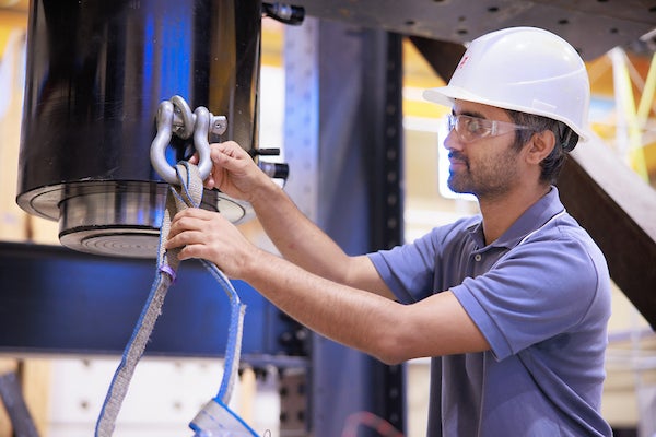 A student works with manufacturing machinery