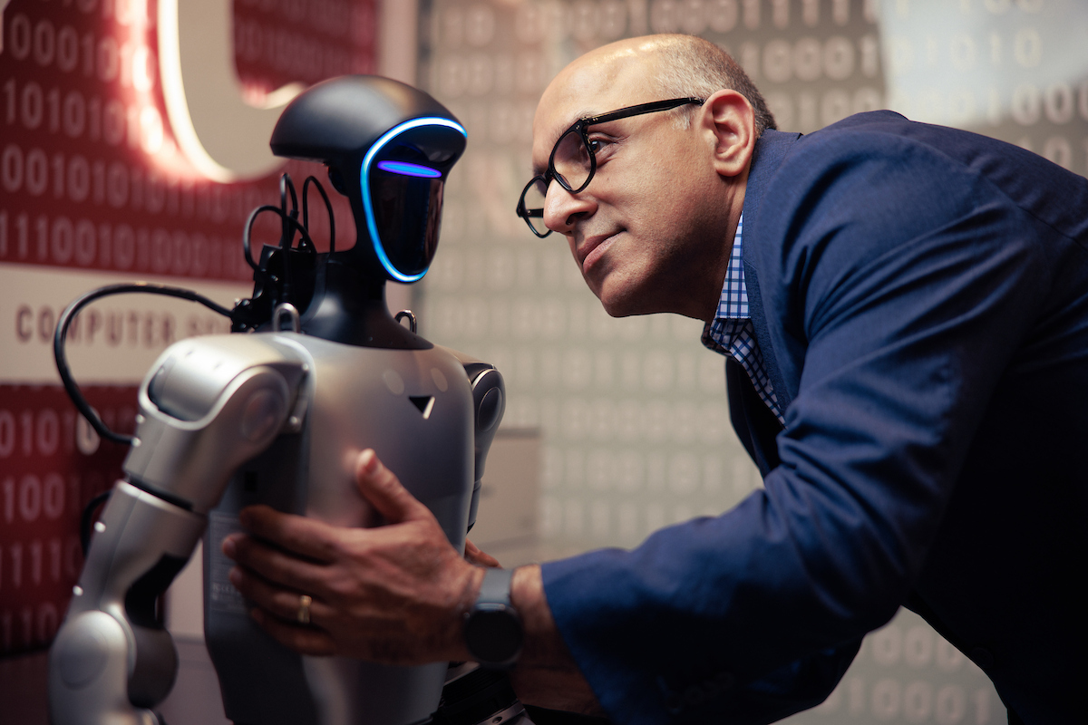 Man looking at robot