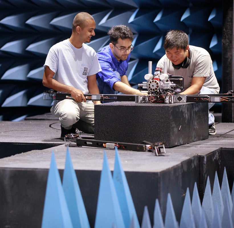 Research students performing an experiment in a lab.
